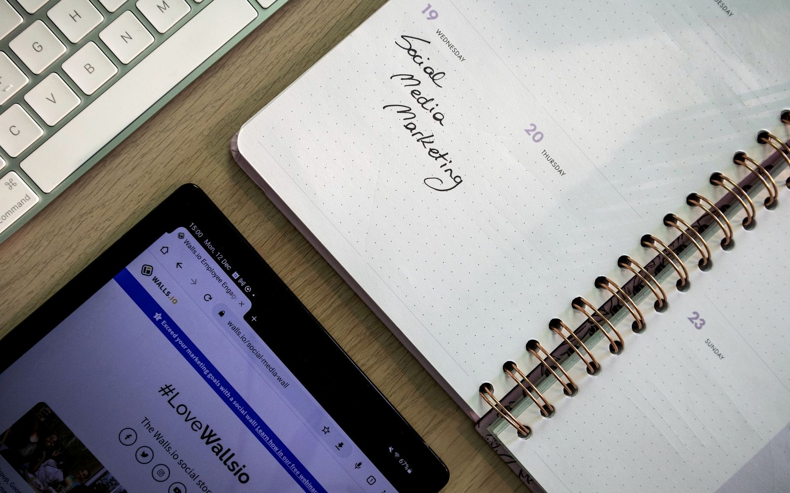 Notebook and phone on a desk prepared for a social media marketing brief