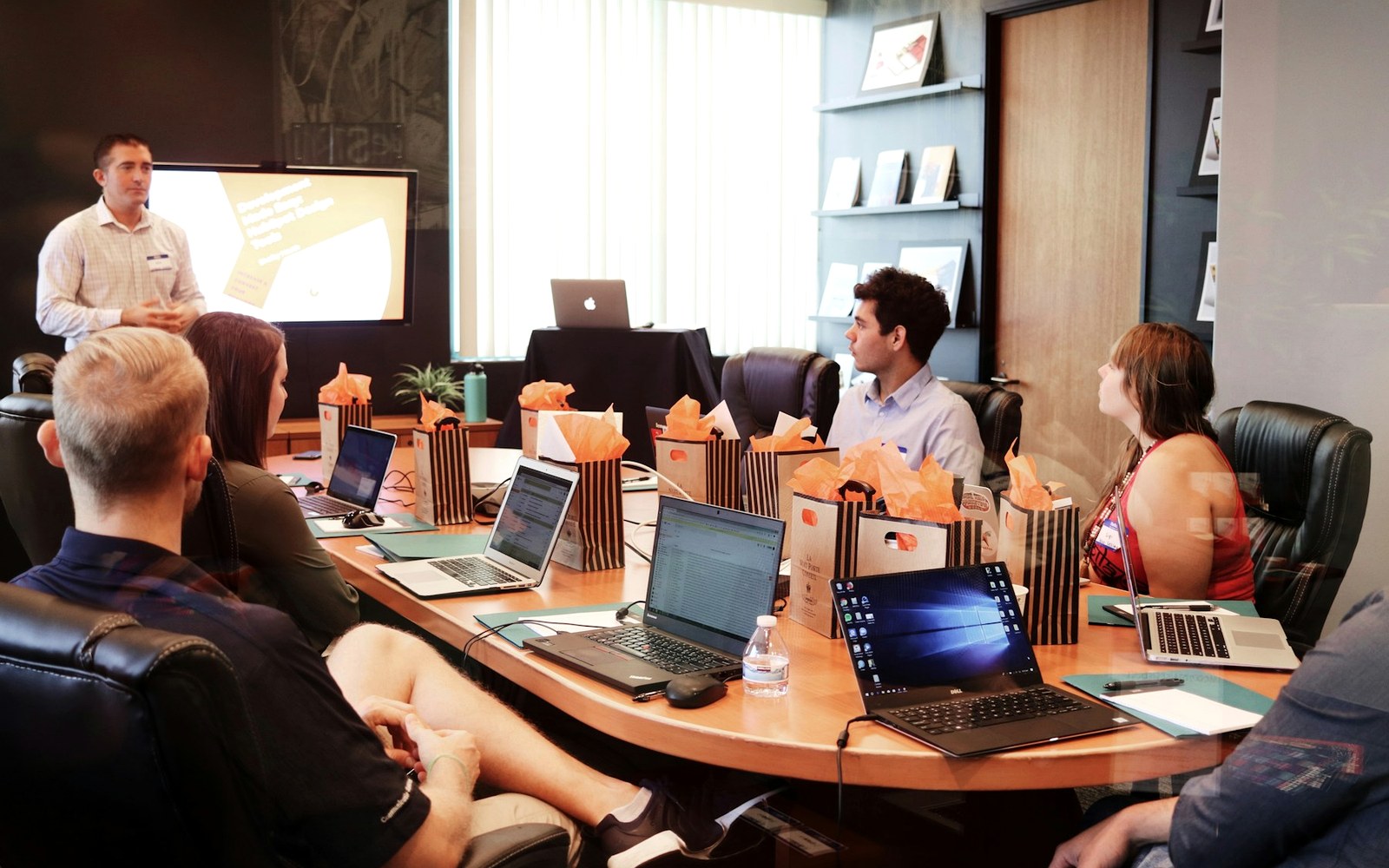 Team discussing campaign standards around an office conference table